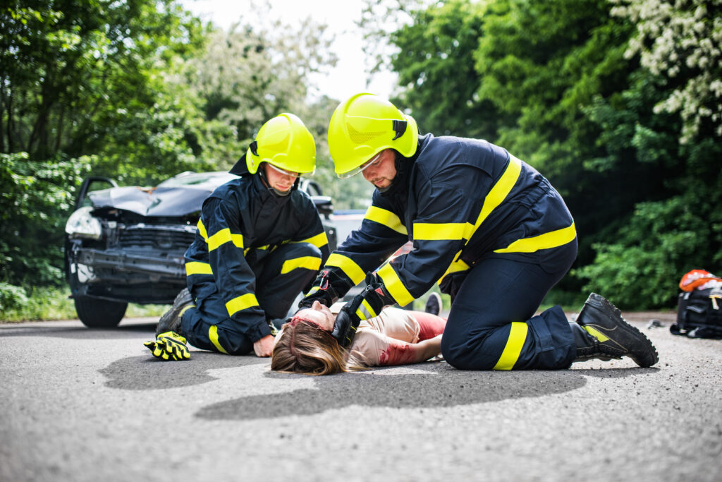 Medics attend to car injury victim
