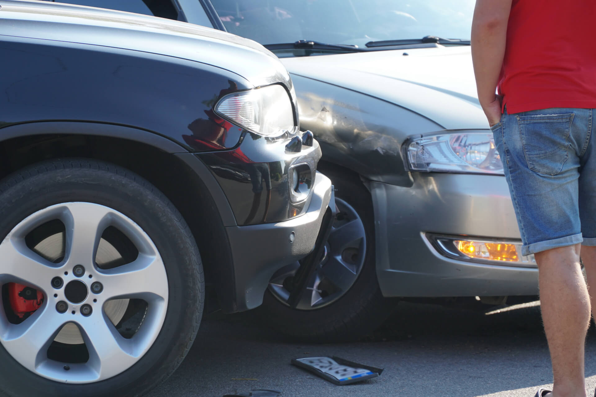 a man looking at his car after an accident that was not his fault