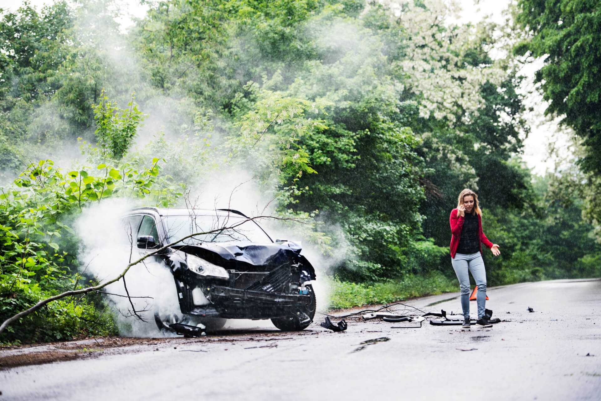 a young woman with a smartphone next to a car after a hit and run