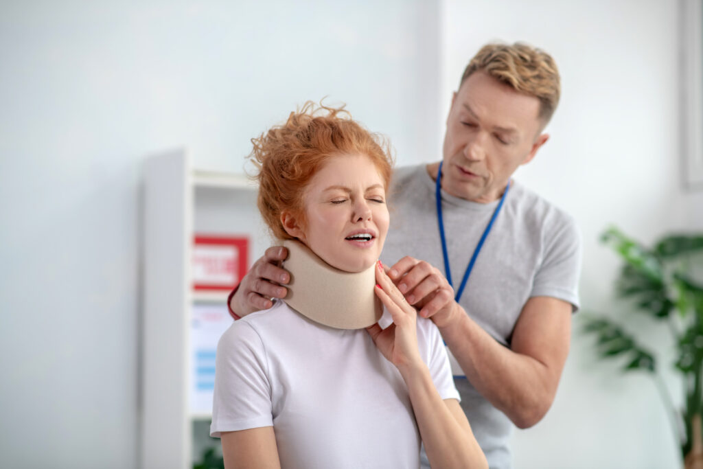 physiotherapist examining neck fixator