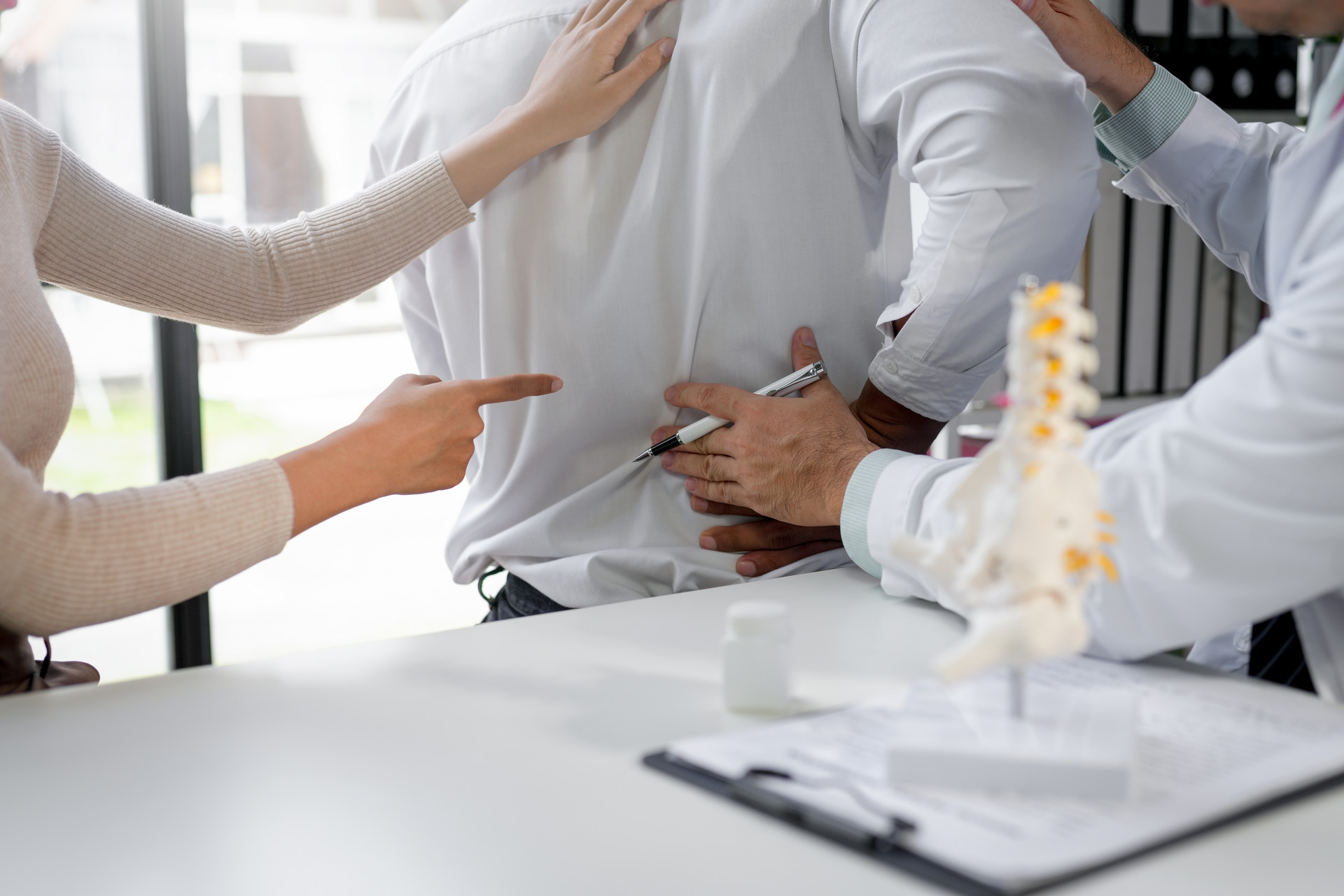 doctor pointing with pen at patient
